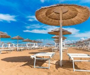 Rimini empty beach with chaise lounges and umbrellas.